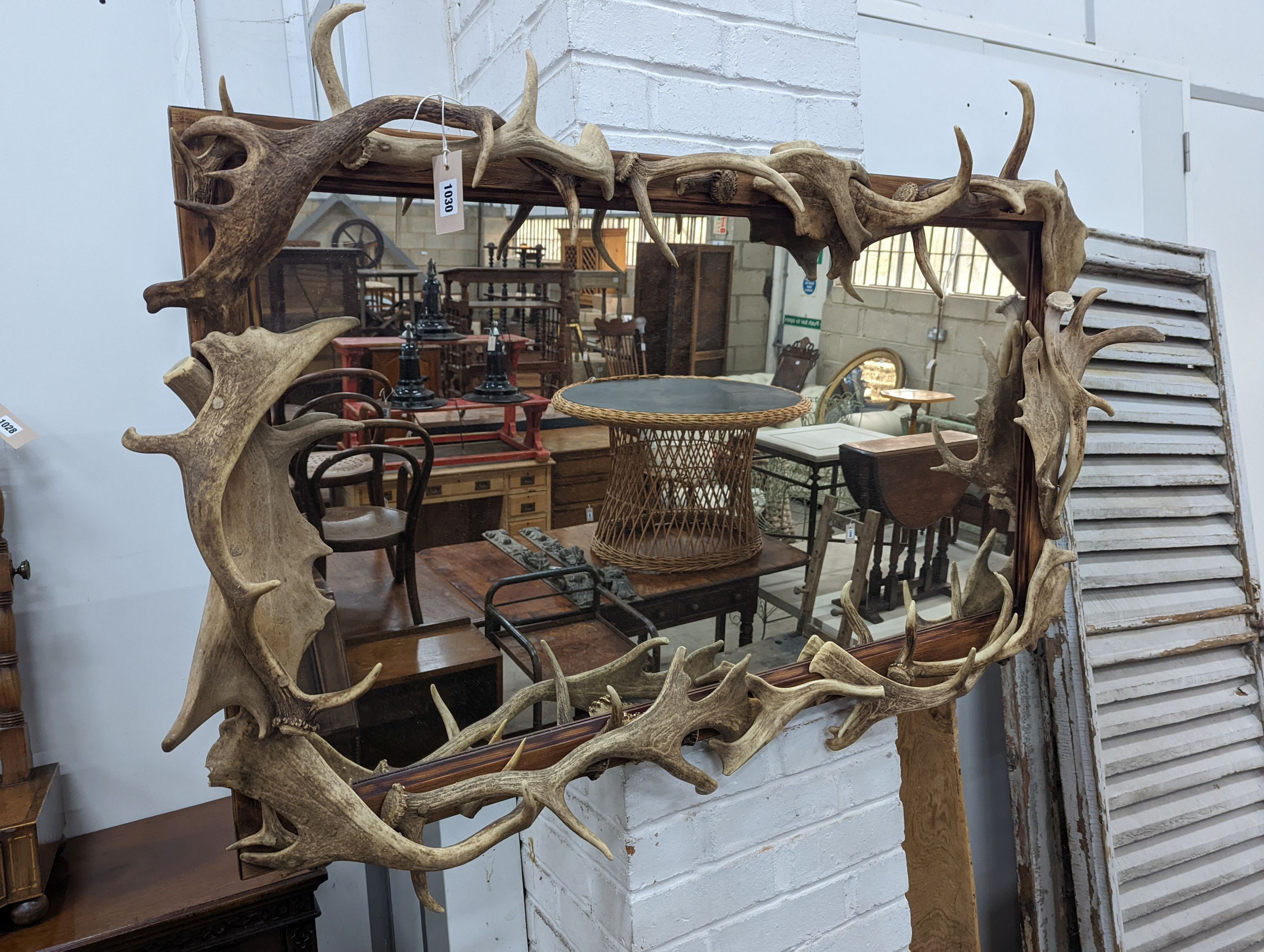 A rectangular moose antler wall mirror, width 132cm, height 80cm